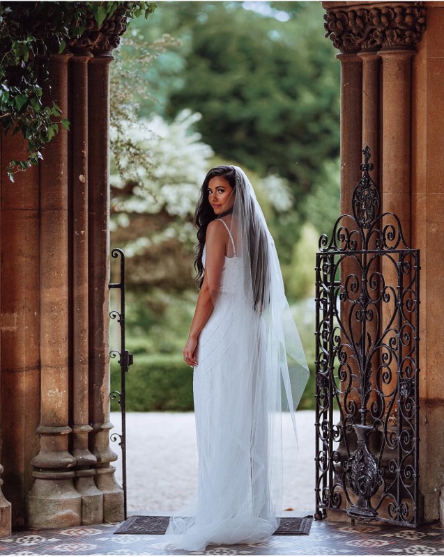 Bride under stone archway